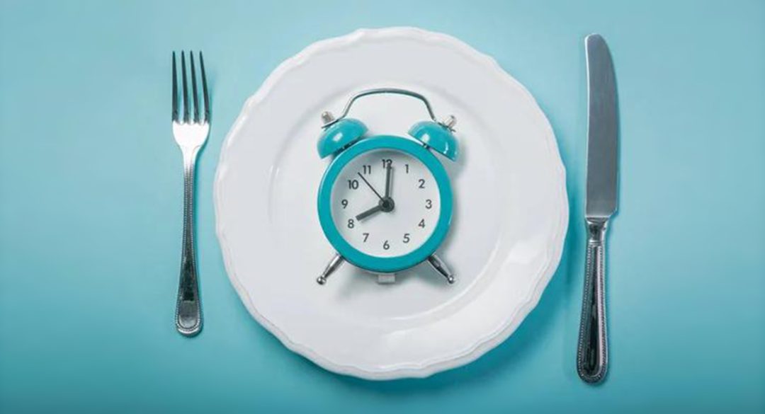 Alarm Clock on Plate with Knife and Fork
