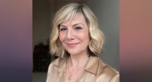 Glynis Wearing Gold Satin Shirt