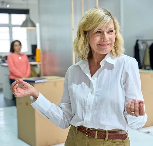 Glynis wearing white shirt for rehearsal