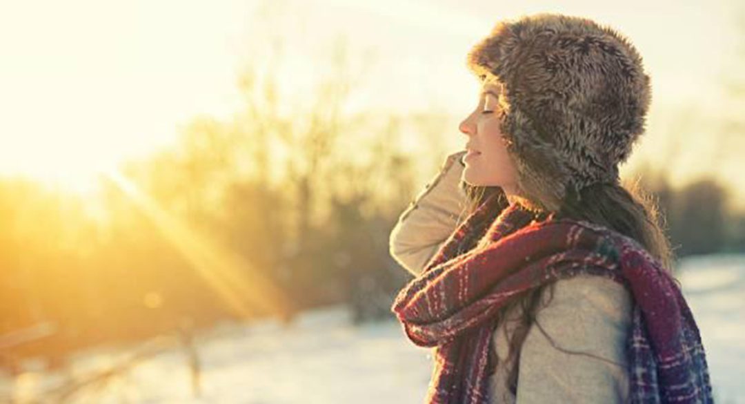 Woman Looking Towards Sun Rise During Winter