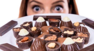 Woman Looking at Plate of Chocolate