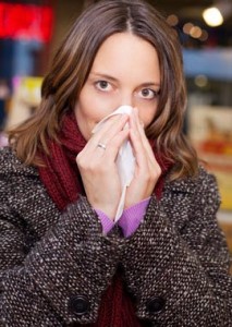 Woman with a runny nose in pharmacy